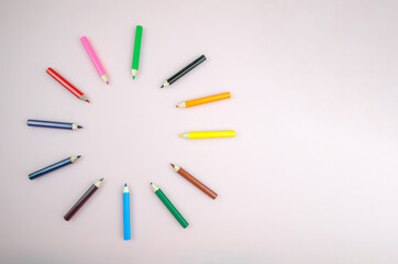 Bright beautiful pencils, 12 pieces. Colored pencils laid out in a circle on a white background close up, copy spase