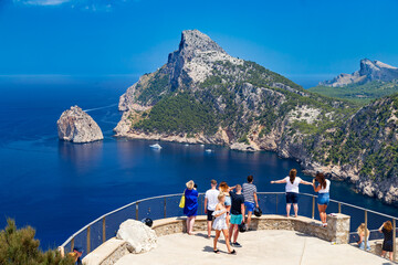 Tourists at vantage point with view Mirador Es Colomer on punta nau at cap formentor majorca...