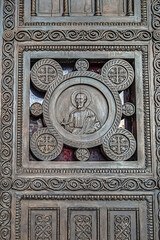 Fragments of the entrance bronze door of the Metropolitan Cathedral of the Annunciation (1862) in Metropolis square in the old town of Athens. Athens, Greece.
