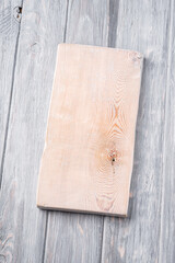 Handcraft white wooden old cutting board, grey background, angle view