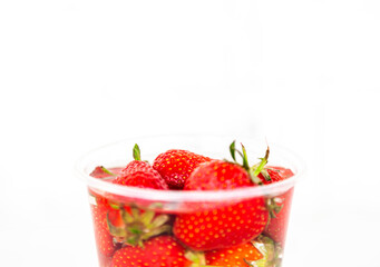 Delicious strawberries in glass bottle isolated on white background and copy space for text.