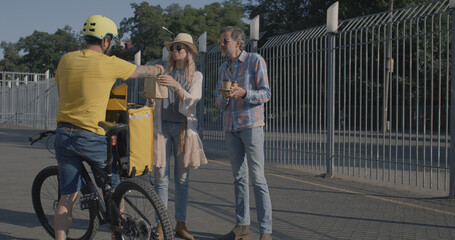 Bicycle messenger delivers food to couple
