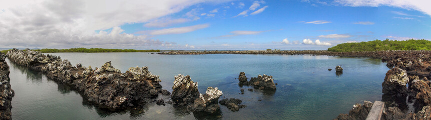Fototapeta na wymiar Panorama: Rocky coast with basalt rocks at Galapagos islands
