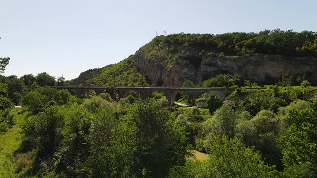 Aerial view of bridge over a forest trees in high mountin hill , transportaion concept