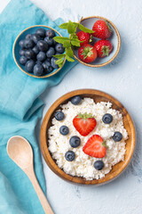 Fototapeta na wymiar Cottage cheese with strawberry and blueberry, healthy breakfast concept, top view