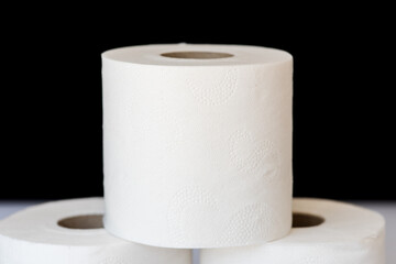 White toilet paper roll on black background