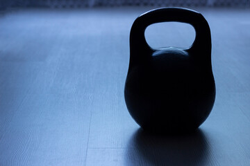 Naklejka na ściany i meble Close-up of a two-pound cast-iron weight on the floor.