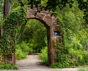 A stone arch leading into a secret garden in Spring, TX.