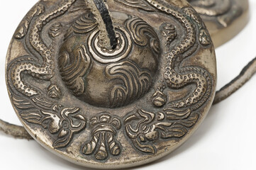 Tibetan Buddhist tingsha cymbal dragons ornament isolated
