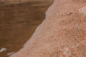 Stones and water in Issyk-Kul Lake, Kyrgyzstan make an abstract background