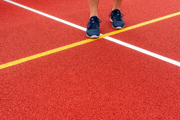 Athlete standing on a red color game court