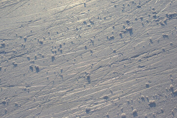 bright traces of ice skating on an ice rink. background and texture