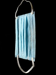 Blue medical mask on black background