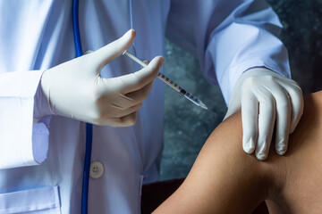 Selective focus,Doctor inject vaccine to patient,Insuline injector