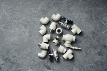 Plumbing background with fittings on a stone background