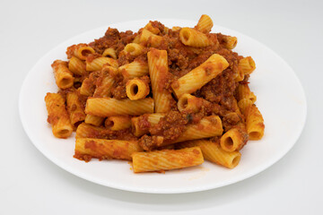 Rigatoni Pasta with a Hearty Bolognese Sauce on a White Plate with a White Background