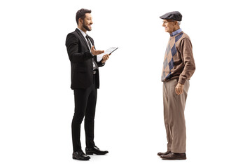 Businessman holding a clipboard and talking to an elderly man