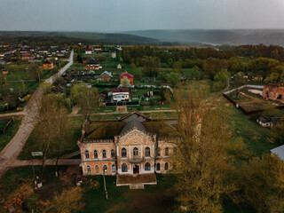 Old abandoned ruined mansion in Gothic style with stained glass windows in Avchurino, aerial view