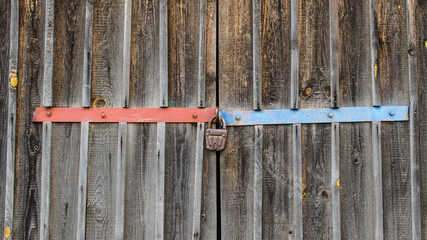 Wooden texture old deadbolt , colored lining and a padlock