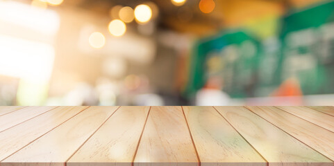 Wooden top table with bokeh light effect and blur restaurant on background, blur background