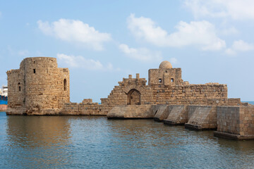Panoramic view of the Sidon Sea Castle in Lebanon. A beautiful fortress and a stone bridge over the blue water. Lebanese city Sayda on the seaside.