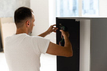 handsome joiner work in carpentry. He is successful entrepreneur at his workplace.