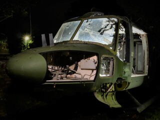 disused abandoned Helicopter grounded at night with daylight quality lighting to show nose body and component parts 