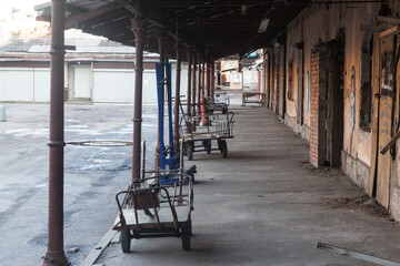 Abandoned warehouse with rusty carts