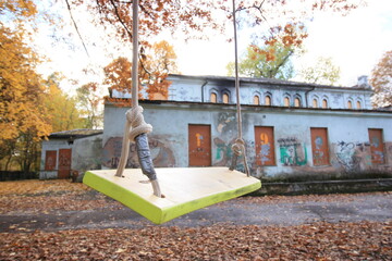 Closeup of swings on the rope in the park in fall 