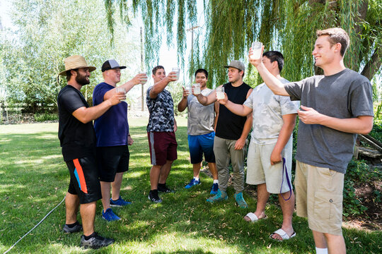 Teammates toasting on the lawn