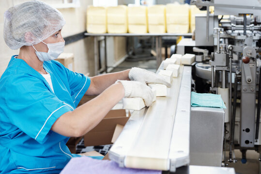 Woman Packaging Butter At Factory