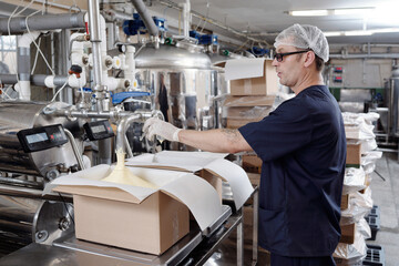 Worker Monitoring Butter Packaging