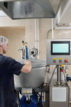 Worker Operating Meat Processing Machine