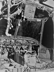 Internal cockpit of disused abandoned Helicopter grounded at night with daylight quality lighting to show controls wiring and component parts 