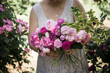 Anonymous florist arranging bridal bouquet