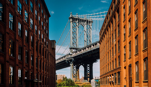 Manhattan Bridge seen from Washington Streei in Dumbo district. Empire State Building is framed in the supports for the bridge
