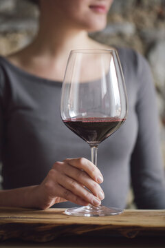 Woman tasting red wine