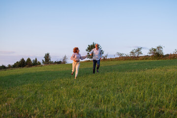 Senior couple running on the field