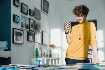 Woman with curly brown hair working in a studio office