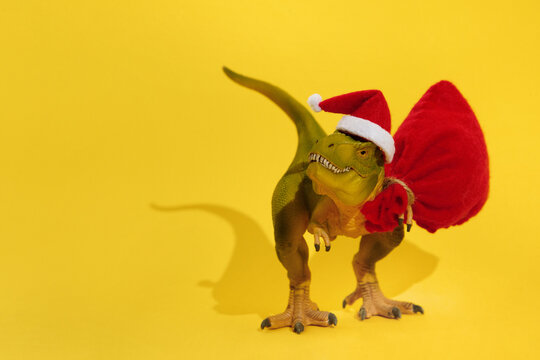 Decorative toy dinosaur holding bag with gifts