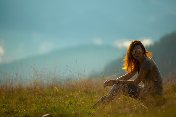 sunny summer day a girl sits in the carpathians