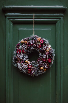 Christmas wreath of branches on a green door
