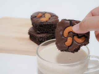Dipping brownie in to milk is good for health, handmade chocolate brownie, cooking at home concept