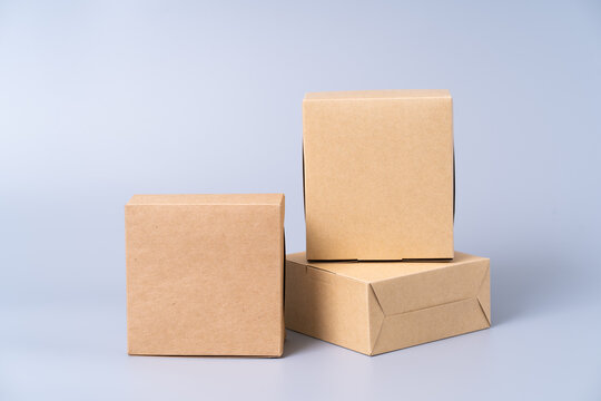 Brown Paper Box For Food Package. Carton On A Gray Background.