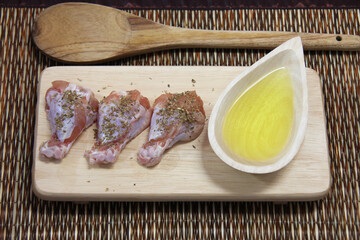 raw chicken on wooden board