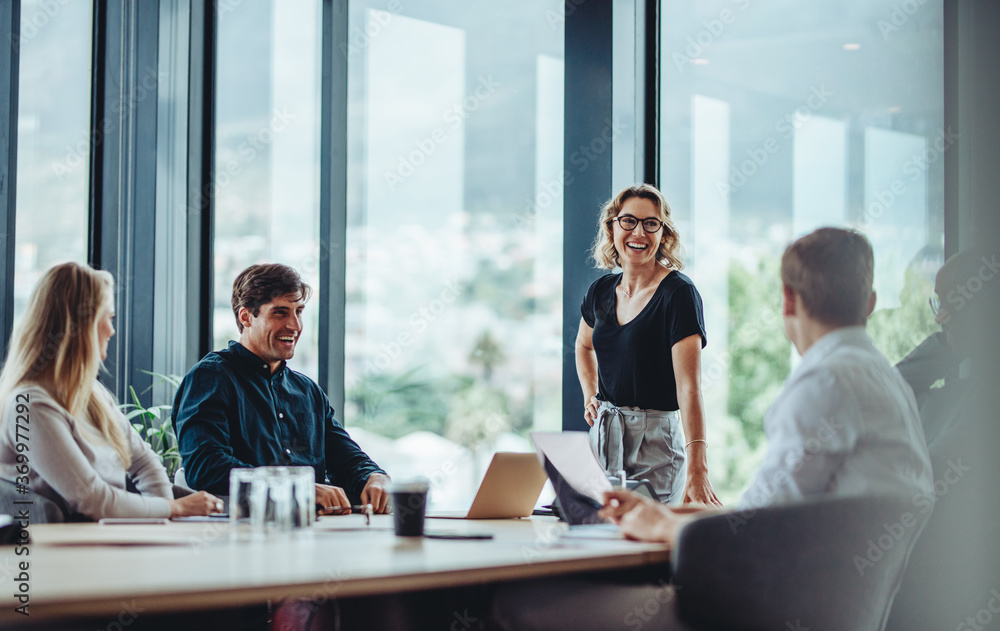 Wall mural business people having casual discussion during meeting