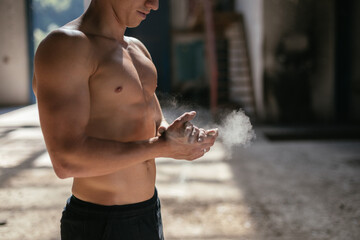 Sportsman clapping hands with chalk