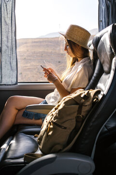 Woman using phone in bus
