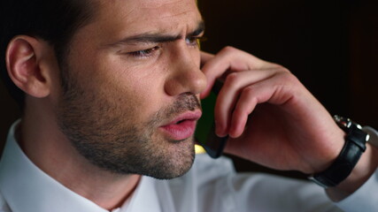 Businessman talking on smartphone. Professional calling on mobile phone indoors