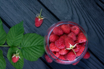 Red raspberries with leaves. Background with raspberries. Raspberry. Close-up